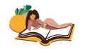 The girl lies on the book and reads it. Home cozy atmosphere of reading books.