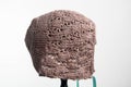 Knit baby bonnet  on light Royalty Free Stock Photo