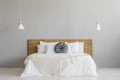 Knit Blanket On Wooden Bed Against Grey Wall In Minimal Bedroom