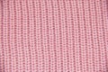 Knit close-up. Colored knitted wool close-up. Pink background. Close up of pink colored wool textile in Hi-Res Royalty Free Stock Photo