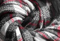 Knit texture of natural soft wool knitted fabric black white red background Royalty Free Stock Photo