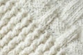 Knit texture of white wool knitted fabric with cable pattern as background. Royalty Free Stock Photo