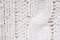 Knit texture of white wool knitted fabric with cable pattern as background Royalty Free Stock Photo