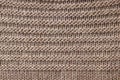 Knitted background of coffee color. Knitted texture. A sample of