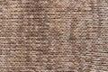 Knitted background. Knitted wallpaper. Beige knitted fabric. Knitted texture.