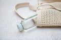 Knitted bag handmade and a bottle of water outdoors. Sustainable shopping. Waste-free lifestyle Royalty Free Stock Photo