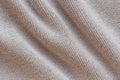 Knitted beige fabric texture with large diagonal fold Royalty Free Stock Photo