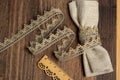 Knitted openwork linen ribbon tapes in rural style of rustics cotton eco natural on wood ground Royalty Free Stock Photo