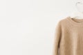 Knitted beige wool pullover on white background Royalty Free Stock Photo