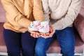 Knitted booties in the hands of a pregnant woman next to her husband. waiting for a miracle Royalty Free Stock Photo