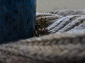 Knitted brown scarf close-up, bumps and part of a blue mug Royalty Free Stock Photo