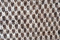 A knitted canvas of woolen threads. Brown and white threads knitting sweaters.
