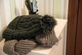 Knitted cap and scarf on the pedestal in the hallway