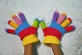 Knitted children's glove with colorful stripes