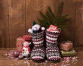 Knitted Christmas boots with a pattern,gifts in bright packaging, confetti. new year`s still life Royalty Free Stock Photo