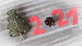 Knitted Christmas tree and figures of the coming New year - 2021 - cut out of paper , on a gray background, top view, close - up- Royalty Free Stock Photo