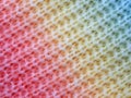 knitted cotton structure with a gradient from red to yellow to blue, close up of knitted cotton surface Royalty Free Stock Photo