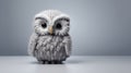 Knitted And Crocheted Tiny Gray Owl On Grey Background