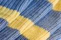 Knitted fabric large knitted yellow with grey stripes horizontally. Royalty Free Stock Photo