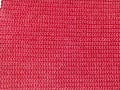 Knitted fabric of pink, crimson color close-up as a background