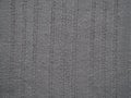 Knitted fabric texture. Gray. Simple knitting with front and back loops. Knitting on the knitting needles. Horizontal lines