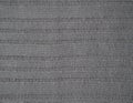 Knitted fabric texture. Gray. Simple knitting with front and back loops. Knitting on the knitting needles. Horizontal lines