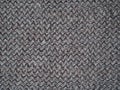 Knitted fabric texture. Gray. Simple knitting with front and back loops. Knitting on the knitting needles. Horizontal lines