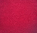 Knitted fabric texture. Red color. Garter stitch with facial loops. Knitting on the knitting needles. Knitted background