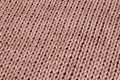 Knitted fabric from woolen threads of beige color without patterns