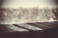 Knitted gray texture on the table on a background of blurred winter nature outside the window Royalty Free Stock Photo