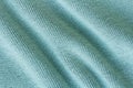 Knitted green fabric texture with large diagonal fold Royalty Free Stock Photo