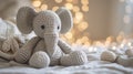 Knitted grey elephant on a bokeh background, a soft knitted elephant toy for children\'s games Royalty Free Stock Photo