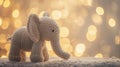 Knitted grey elephant on a bokeh background, a soft knitted elephant toy for children\'s games Royalty Free Stock Photo