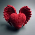 A knitted handmade red heart with wings