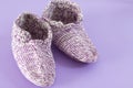 Handmade wool socks on violet background Royalty Free Stock Photo