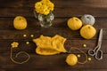 Knitted kids wear of yellow color on a dark wooden background