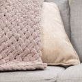 Knitted light pink plaid handmade close-up. Royalty Free Stock Photo