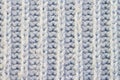Knitted light woolen blue pattern with stripes braided surface macro Royalty Free Stock Photo