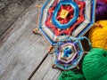 Knitted mandala and yarn on rustic table