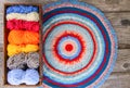 Knitted mat and colorful skeins of wollen yarn Royalty Free Stock Photo