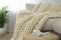 Knitted merino wool plaid on sofa in room Royalty Free Stock Photo