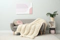 Knitted merino wool plaid on sofa in room Royalty Free Stock Photo