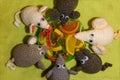 Knitted mice are placed around a plate with marmalade.