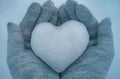Knitted mittens with heart of snow in winter. Love concept. Valentine day background. Royalty Free Stock Photo