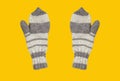 Knitted mittens isolated on a yellow background Royalty Free Stock Photo