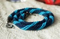 Knitted necklace from blue beads of two shades