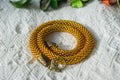 Knitted necklace from transparent yellow beads
