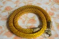 Knitted necklace from yellow beads