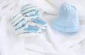 Knitted newborn baby booties and hat on crocheted blanket white background Royalty Free Stock Photo