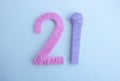 Knitted numbers 21 made of pink and lilac threads Royalty Free Stock Photo
